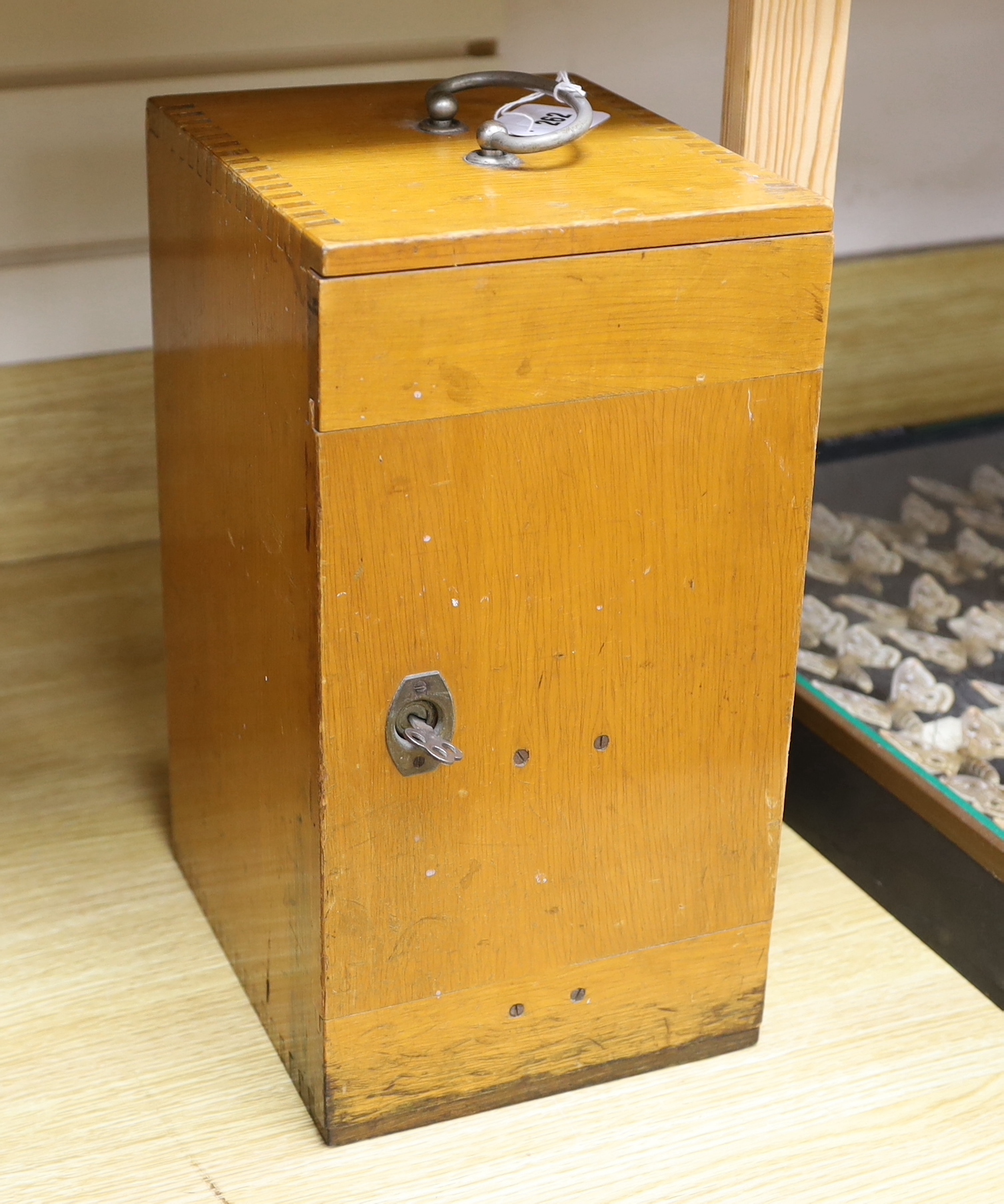 An early 20th century Leitz microscope in a teak case, with alternative lenses, card inserts and sliding compartment with glass slides, matching serial numbers stamped onto case and on magnification table